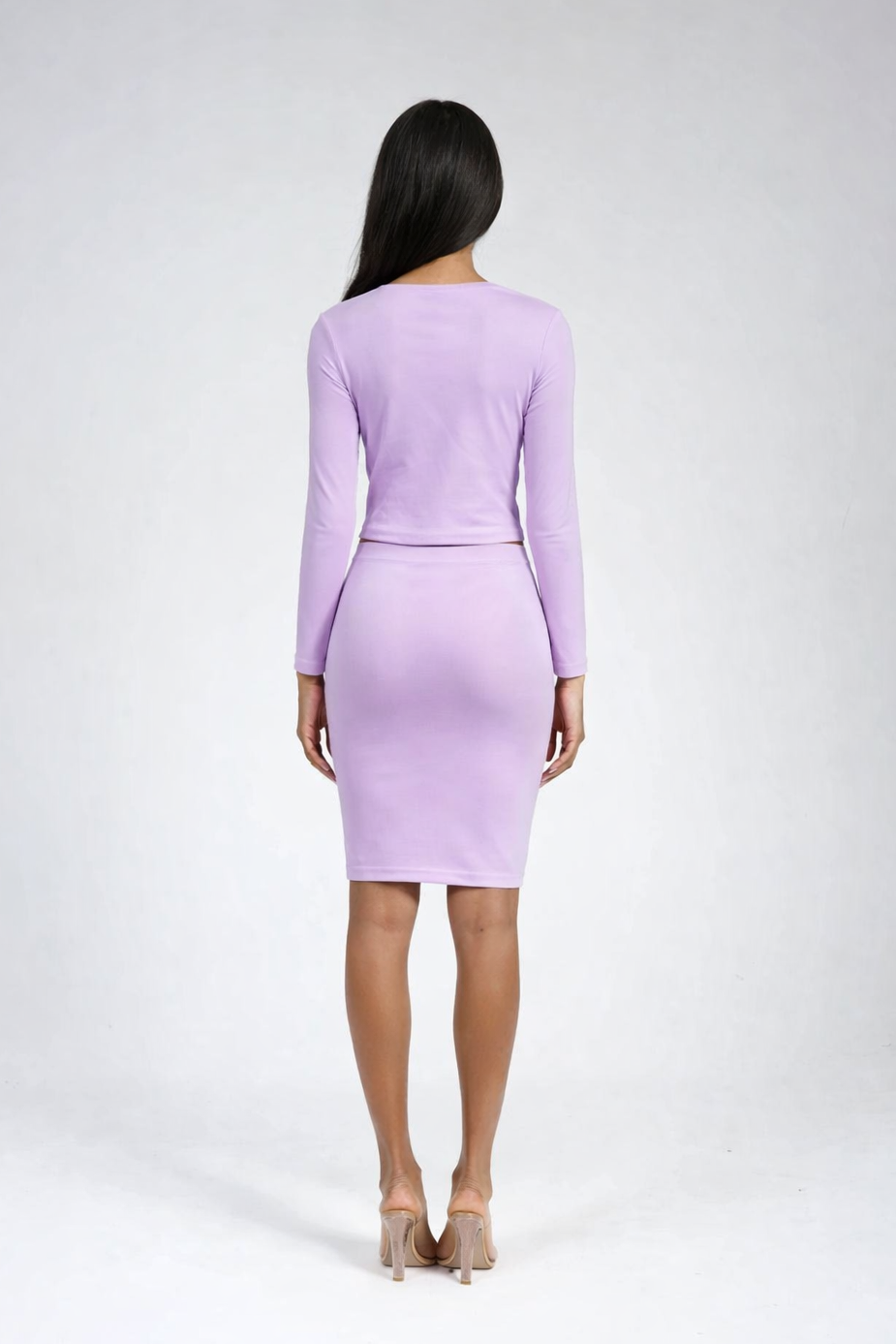 Woman wearing a light purple dress against a white background