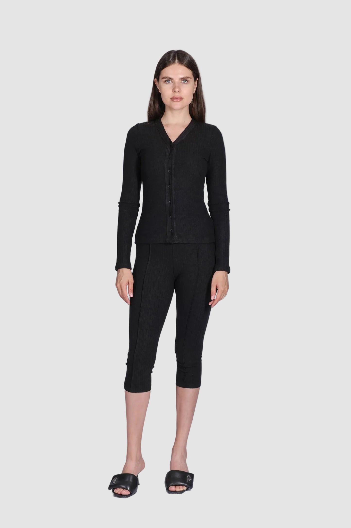 Woman wearing a black outfit on a white background