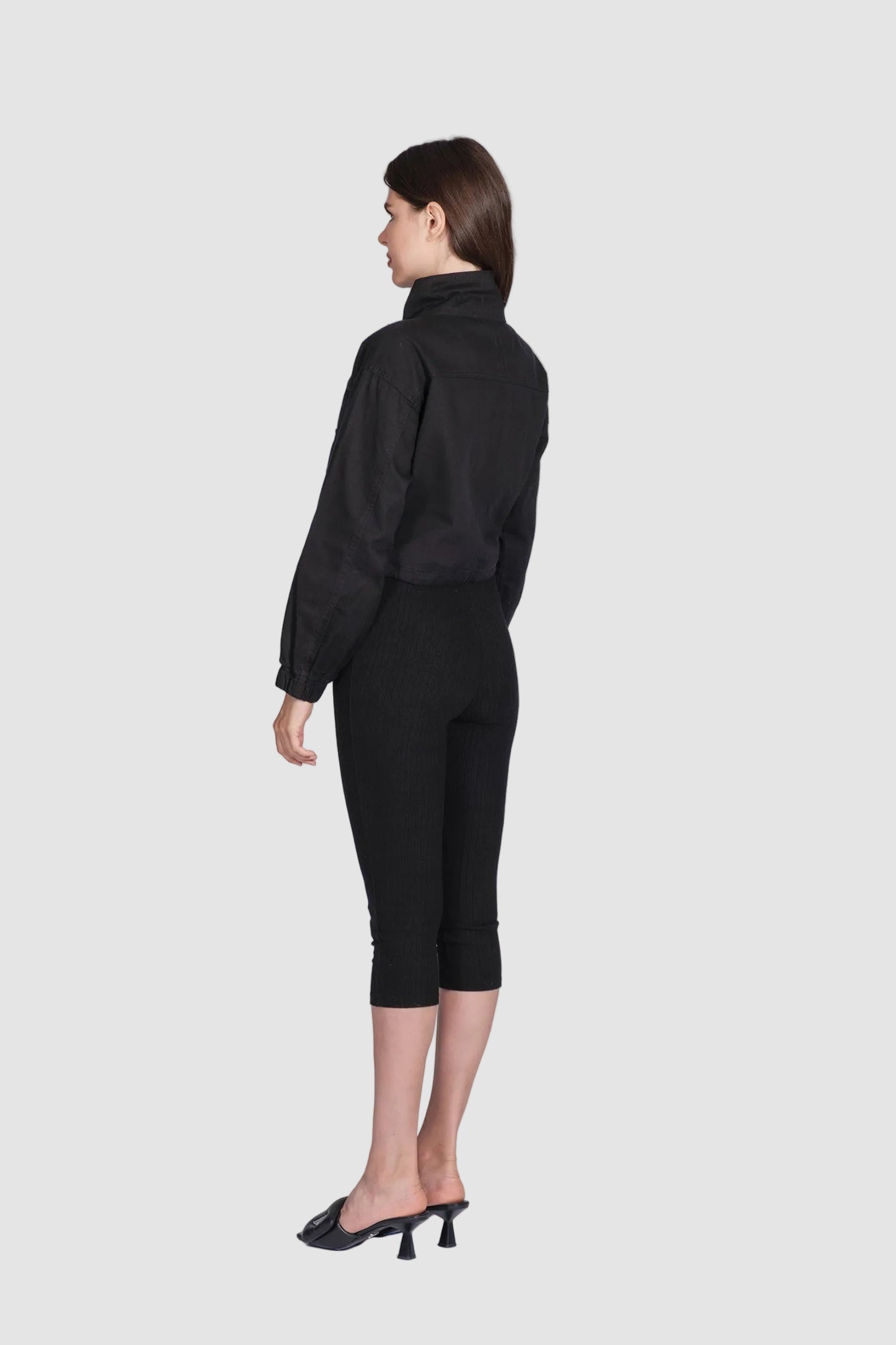 Woman wearing a black outfit on a white background