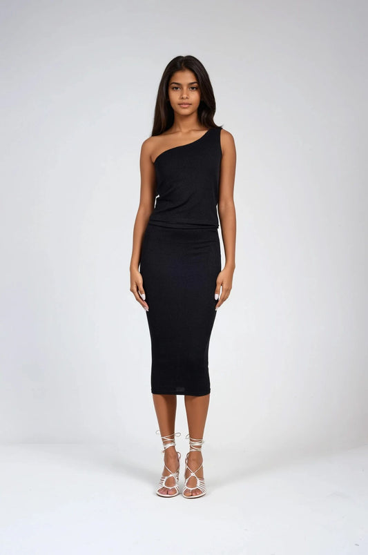 Model in ribbed one shoulder top with matching skirt in black