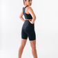 Woman wearing a black athletic outfit on a white background