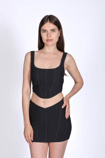 Woman wearing a black compression garment on a white background