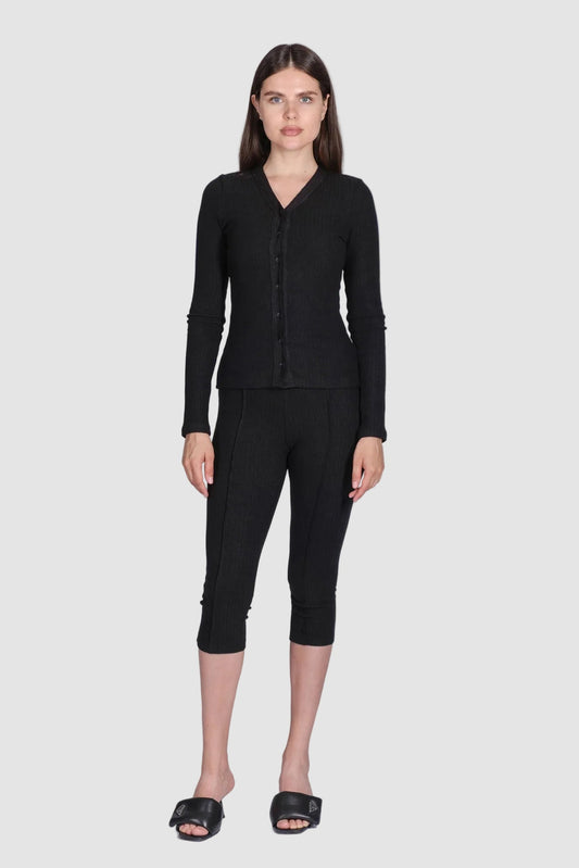 Woman wearing a black outfit on a white background