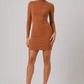 Woman wearing a brown dress on a gray background
