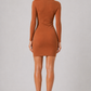 Woman wearing a brown dress on a plain background