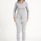 Model in grey zip top against white background.