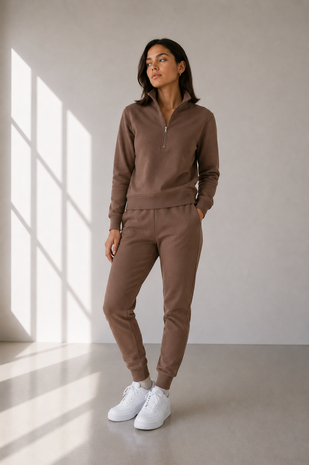 Model in half zip sweatshirt and sweatpant in mocha brown color.