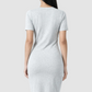 Woman wearing a gray dress on a white background