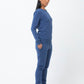 Model in indigo blue cotton sweatpants with matching sweatshirt