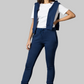 Woman wearing a navy blue vest and pants with a white shirt on a gray background