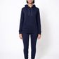 Person wearing a navy blue hoodie and jogger set on a white background