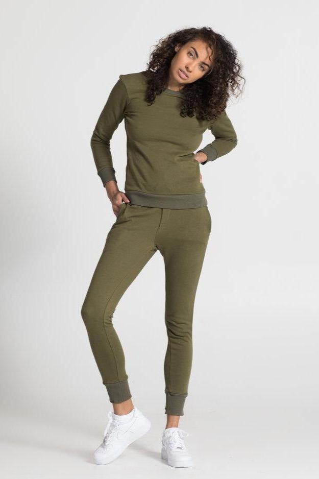 Model in olive green cotton sweatpants for women with matching sweatshirt