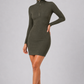 Woman wearing a green dress with a zipper on a gray background