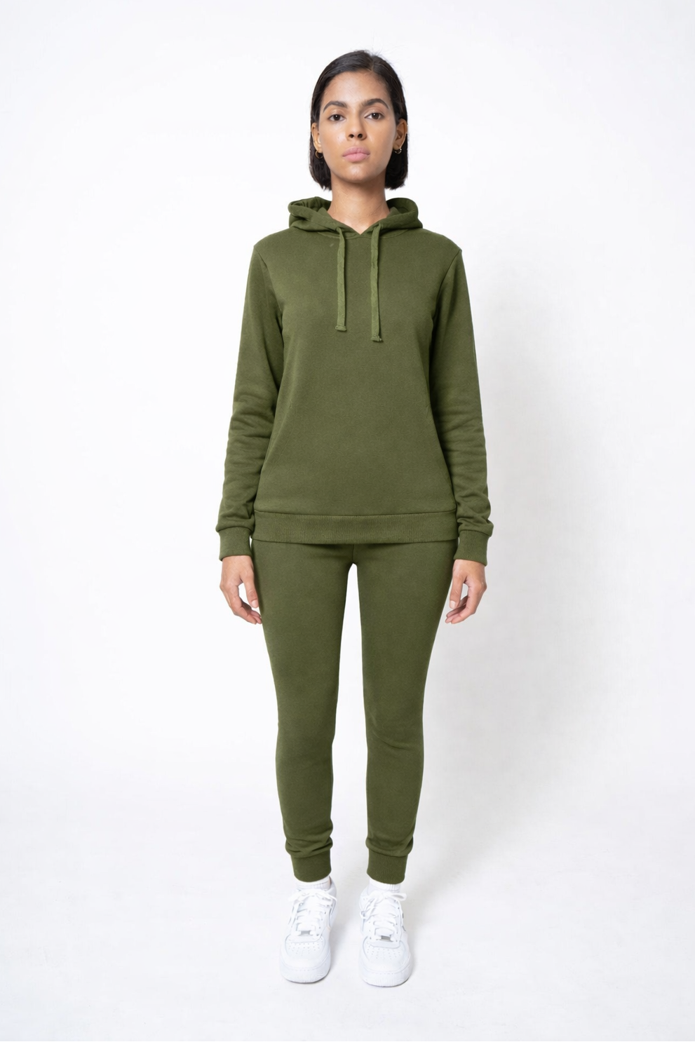 Person wearing an olive green hoodie and jogger set on a white background