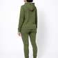 Person wearing a green tracksuit on a white background