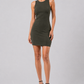 Woman wearing a green dress on a gray background