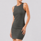 Woman wearing a gray dress against a plain background