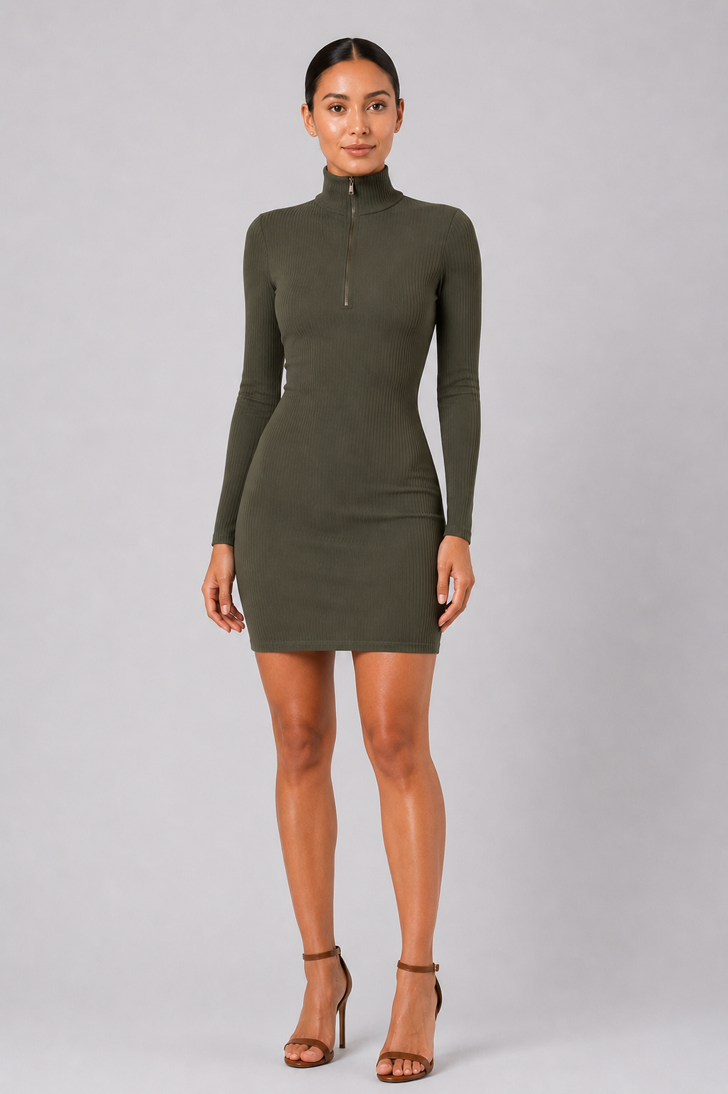 Woman wearing a green dress against a gray background