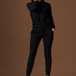 Woman wearing a black outfit against a brown background