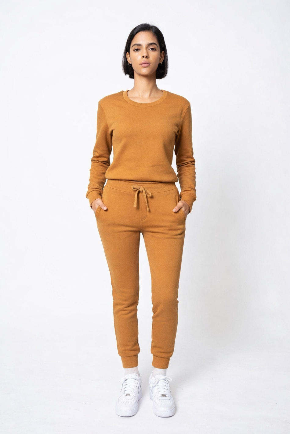 Woman wearing a mustard yellow outfit on a white background