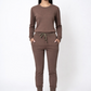 Woman wearing a brown tracksuit on a white background