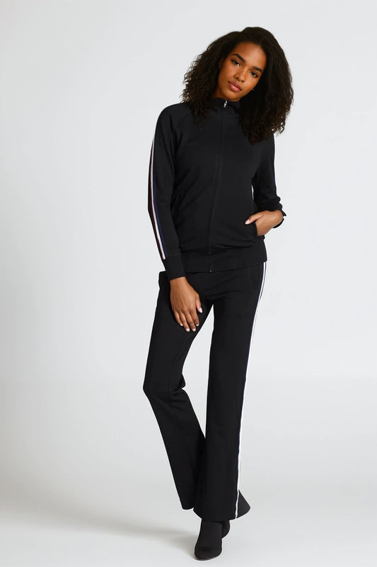 Woman wearing a black outfit with white stripes on a white background