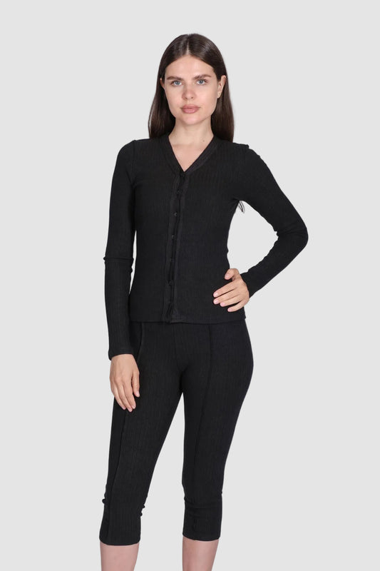 Woman wearing a black outfit on a white background