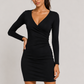 Woman wearing a black dress on a plain background