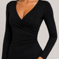 Black long-sleeve dress worn by a model on a plain background