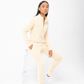 Person wearing a light yellow tracksuit on a white background